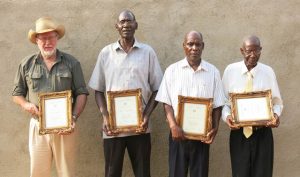 FOUNDER MEMBERS OF THE MAHENYE CAMPFIRE PROJECT RECEIVING AN AWARD
(CLIVE STOCKHIL ON THE LEFT)
(From the talk by Clive Stockil "History of the First Campfire Project in Zimbabwe")